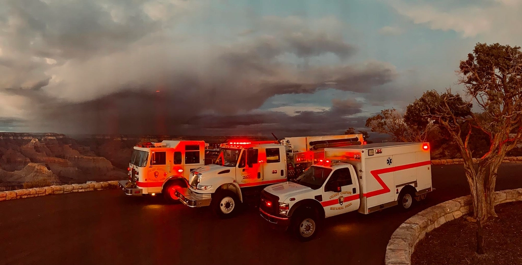 Fire engines with lights and sirens in tribute to fallen firefighters