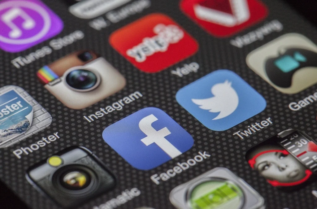 Person using smartphone with social media apps on screen