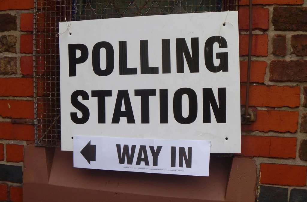 Person casting ballot at polling station