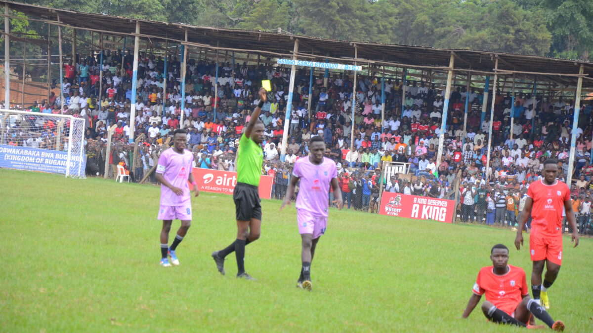 Referee showing a yellow card during a football match